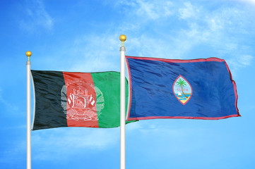 Afghanistan and Guam  two flags on flagpoles and blue cloudy sky