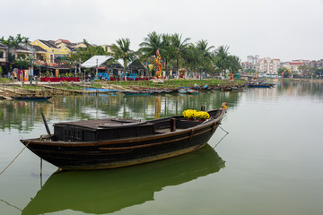 A wooden fishing boat on the river in Hoi An, Vietnam