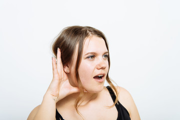 Overhears a woman, tries to listen.