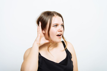 Overhears a woman, tries to listen.