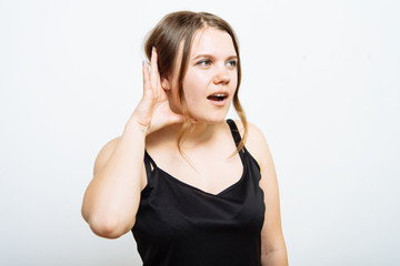 Overhears a woman, tries to listen.