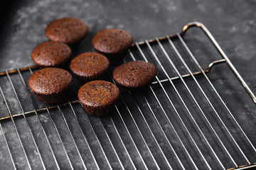 Chocolate cupcakes, muffins with banana and nuts, on a black table and a dark background. Top view, side view. Close-up and medium plan. Space for text.