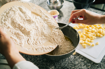 A woman prepares the ingredients to make a sponge cake in her home kitchen