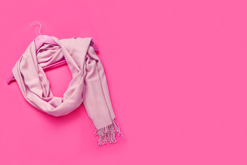 Beautiful pink woolen scarf on paper background.