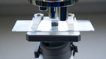 silver microscope in the sunlight from the window