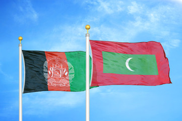 Afghanistan and Maldives  two flags on flagpoles and blue cloudy sky