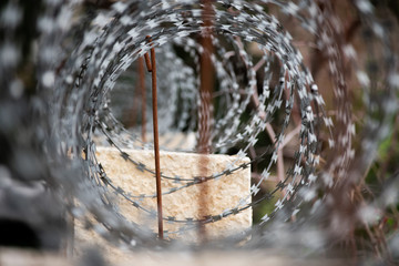 View through a barbed wire roll on a wall