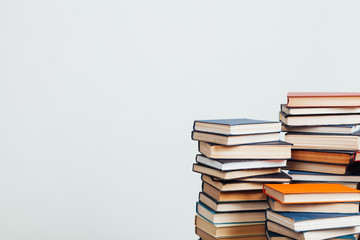 many stacks of educational books at home preparing for exams on a white background