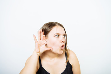 Overhears a woman, tries to listen.