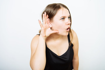 Overhears a woman, tries to listen.