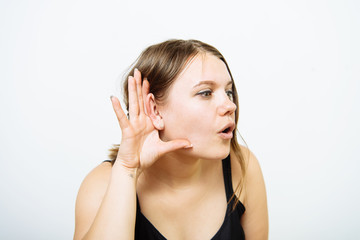 Overhears a woman, tries to listen.