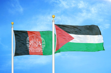 Afghanistan and Palestine  two flags on flagpoles and blue cloudy sky