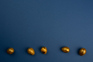 Golden easter eggs on blue