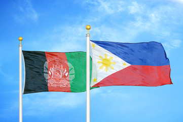 Afghanistan and Philippines  two flags on flagpoles and blue cloudy sky