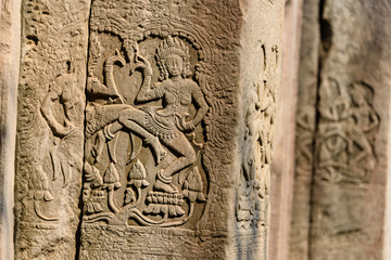 Picturial stories carved into the wall at the Unesco World Heritage site of Ankor Thom, Siem Reap, Cambodia