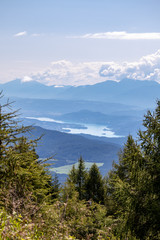 Panorama of the Austrian Alps,Europe,at Lake Ossiacher See with the mountains of the Karawanken Mountains with paragliders