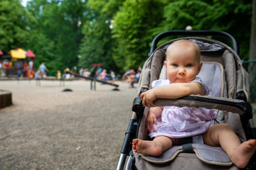 a small child on the playground in a pram