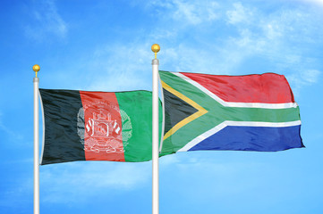Afghanistan and South Africa  two flags on flagpoles and blue cloudy sky