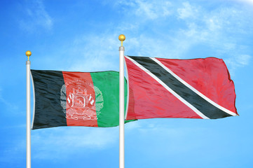 Afghanistan and Trinidad and Tobago  two flags on flagpoles and blue cloudy sky