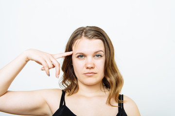 Fototapeta premium Woman holding a finger near her temple