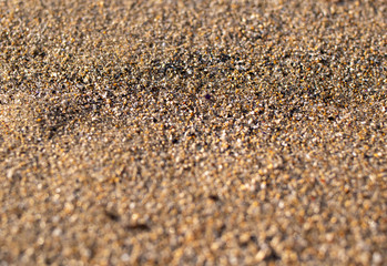 close up of sand on a beach with sun