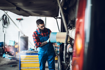 Professional car mechanic working in vehicle repair service.