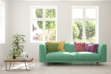 White living room with sofa and summer landscape in window. Scandinavian interior design. 3D illustration