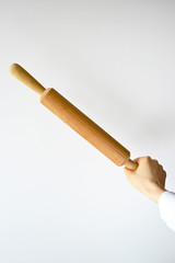Wooden rolling pin in a human arm