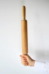 Wooden rolling pin in a human arm