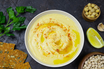 chickpeas hummus with olive oil on a black background