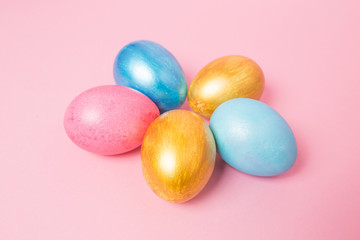Fototapeta na wymiar Multi-colored Easter eggs on a pink isolated background. Easter is a bright holiday.