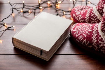 white book and red boots with christmas lights