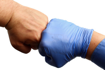 Doctor's hand in a medical glove and patient's hand clenched in fists, on a white background,...