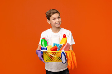 Teen boy holding set of cleaning supplies