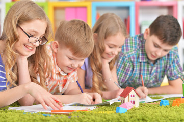 Fototapeta premium Close up portrait of group of children drawing with pencils