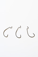 Extremely sharp fishing hook isolated on pure white with reflection