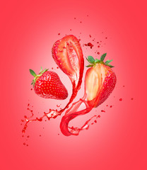 Juice splashes out from cutted strawberries on a red background © Krafla