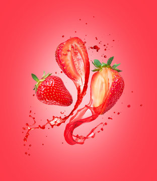 Juice splashes out from cutted strawberries on a red background