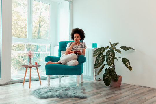 Woman reading a book at home