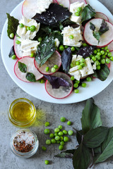 Healthy salad with basil, radish, white cheese and green peas. Cooking at home. Radish Salad. Vegetarian diet. Keto diet. Keto salad.
