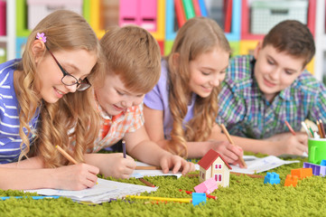 Fototapeta premium Close up portrait of group of children drawing with pencils