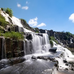 Fototapeta na wymiar Waterfall and blue sky in Ha Giang, Vietnam