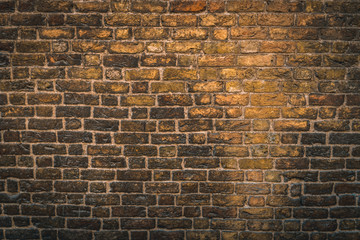 Yellow wall made of dirty bricks