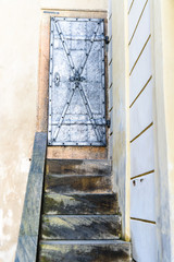 Steps leading up to an old, secure, iron door outside a European Castle
