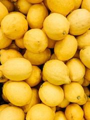 lots of ripe delicious yellow lemons for eating like a background