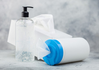 Plastic container with alcohol wipes with hand sanitizer plastic container and box of tissues on...