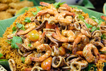 Pile of prawns, squid, octopus and noodles at a street food stall, Bangkok, Thailand