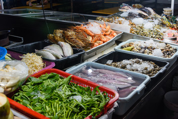 Raw fish and seafood in the kitchen of a street food restaurant, Bangkok, Thailand