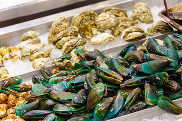 Green-lipped mussels and oysters for sale in a Thai food market.