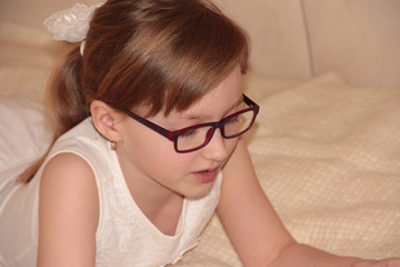 Fototapeta premium Beautiful girl in purple glasses. Cute baby
